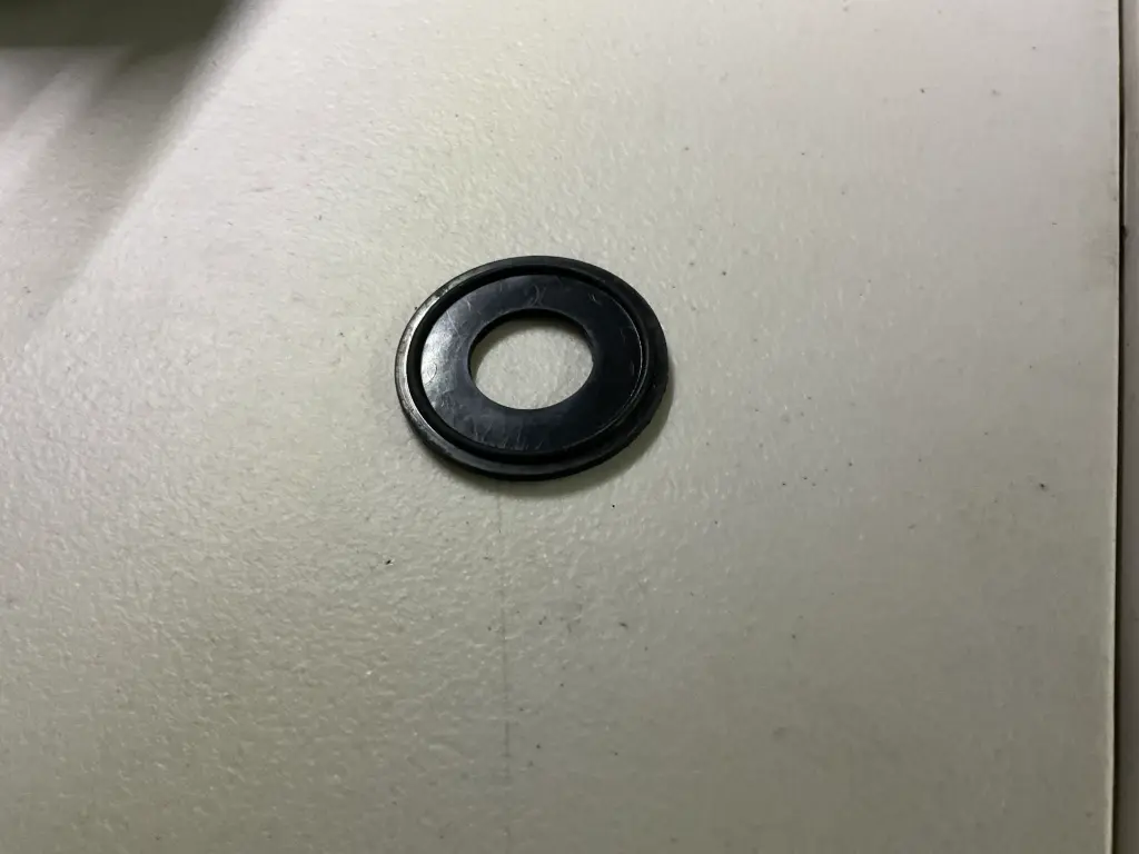 Viton® (FKM) tri-clamp gasket with integrated 150-mesh stainless steel screen for combined sealing and particulate filtration in sanitary process lines.